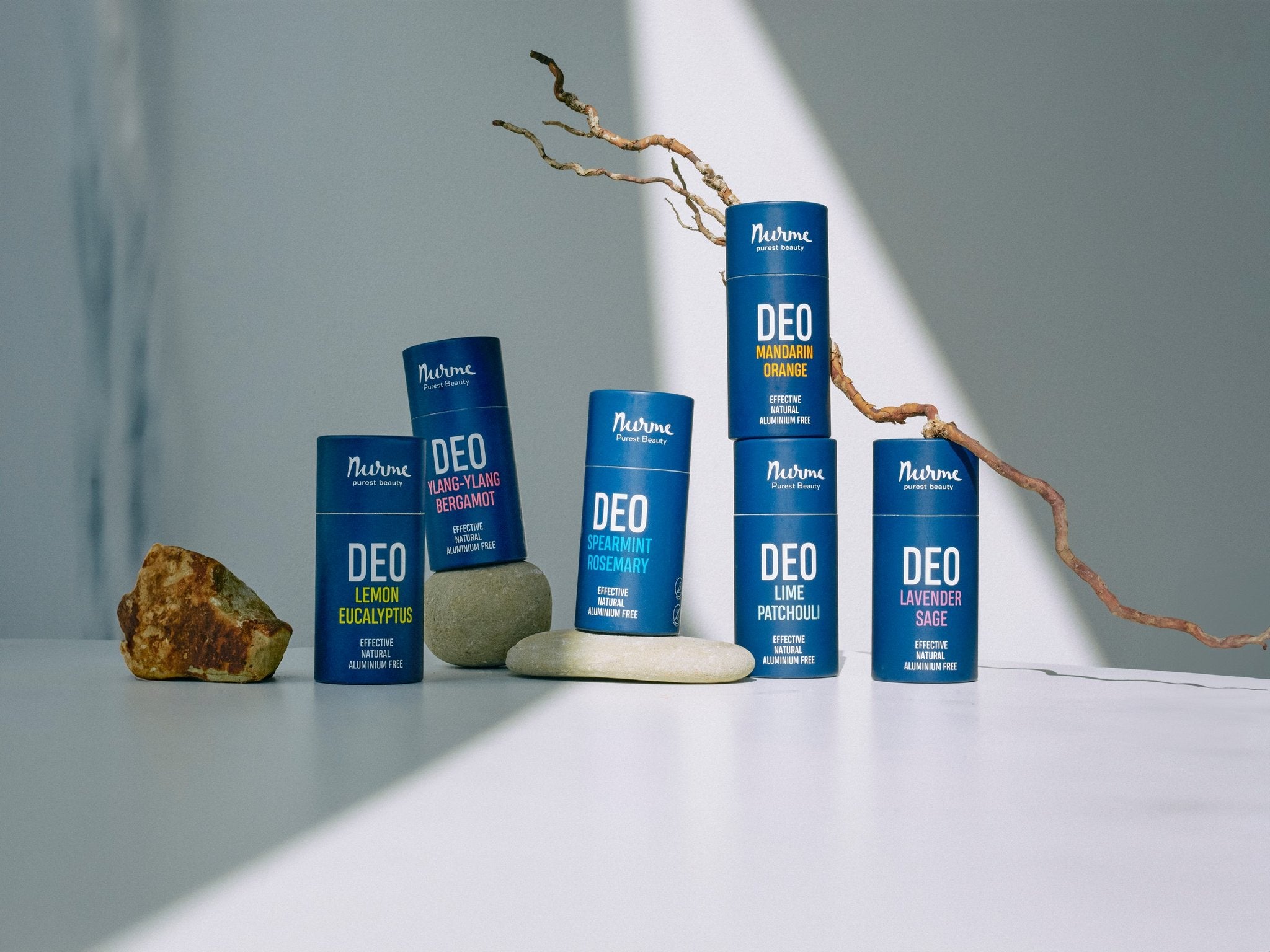 1. Assorted Nurme natural deodorants in different scents displayed on a white surface with natural elements