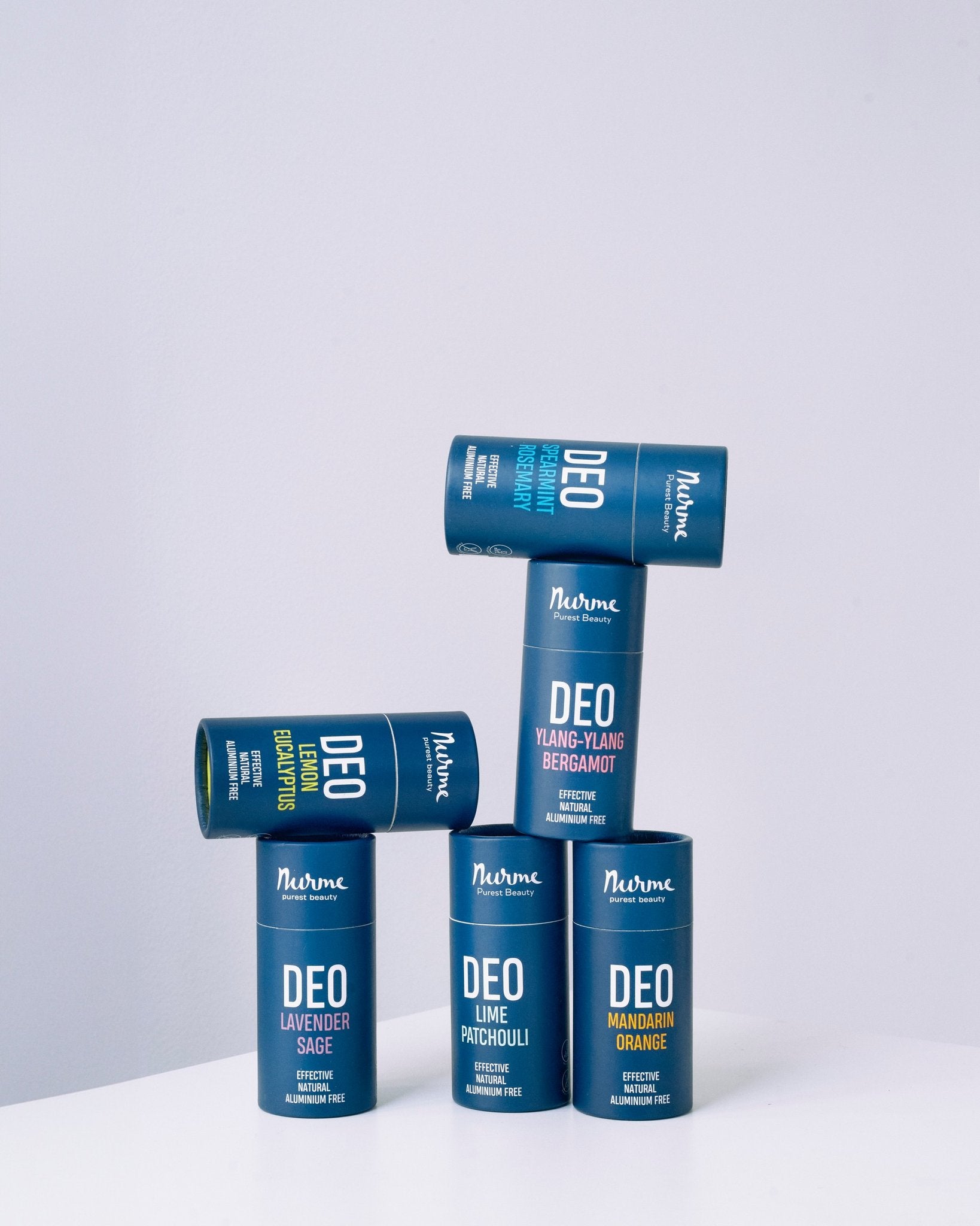 1. Collection of Nurme natural deodorants in various scents stacked creatively on a white background