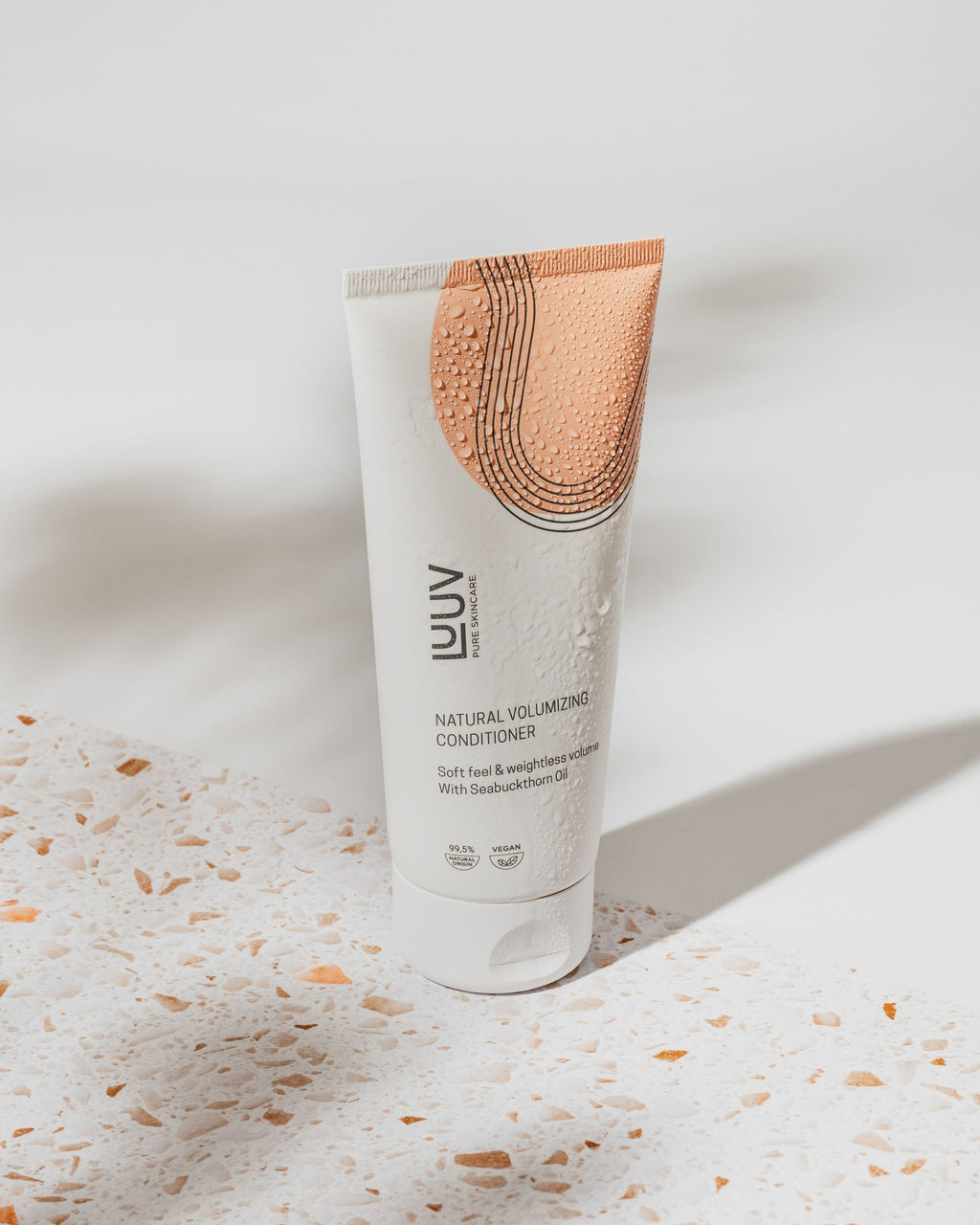 1. LUUV Natural Sea Buckthorn Conditioner 200ml in lifestyle setting with terrazzo surface