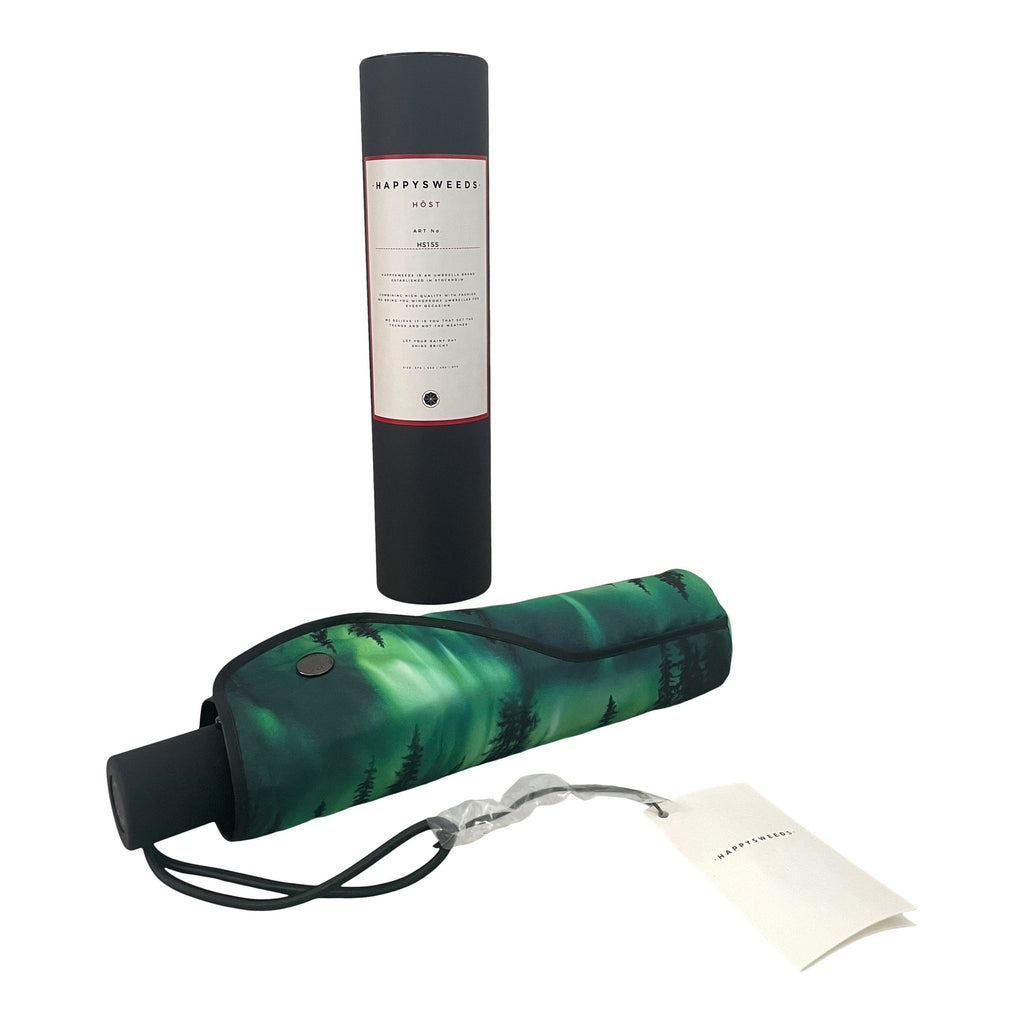 4. Norrsken umbrella folded in cover with Northern Lights design next to black packaging
