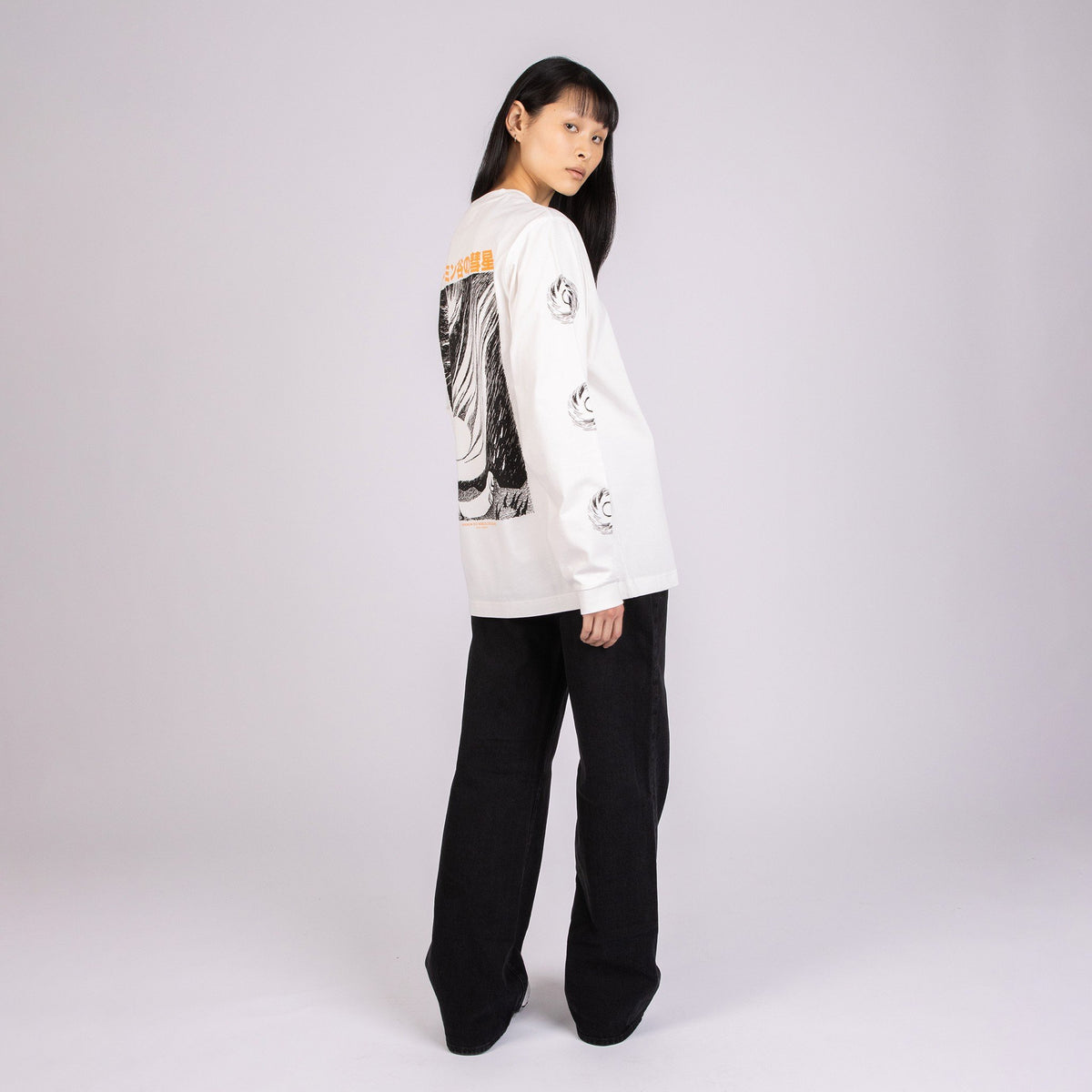 2. Women's white Moomin longsleeve shirt with bold illustration, shown from the back in studio setting