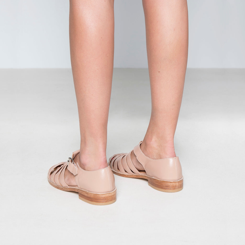 2. Back view of women's handmade leather fisherman sandals in white, highlighting round toe and stacked heel
