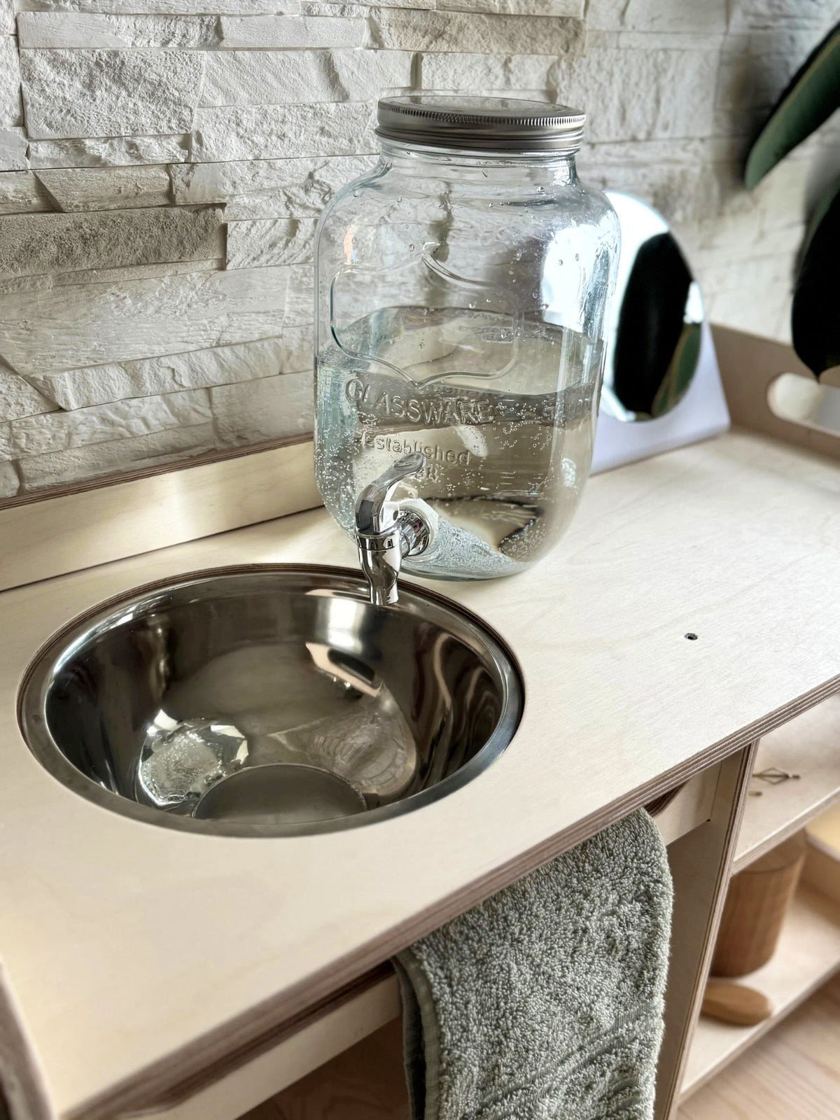 6. Montessori washbasin with enamel bowl and water jar in a natural setting