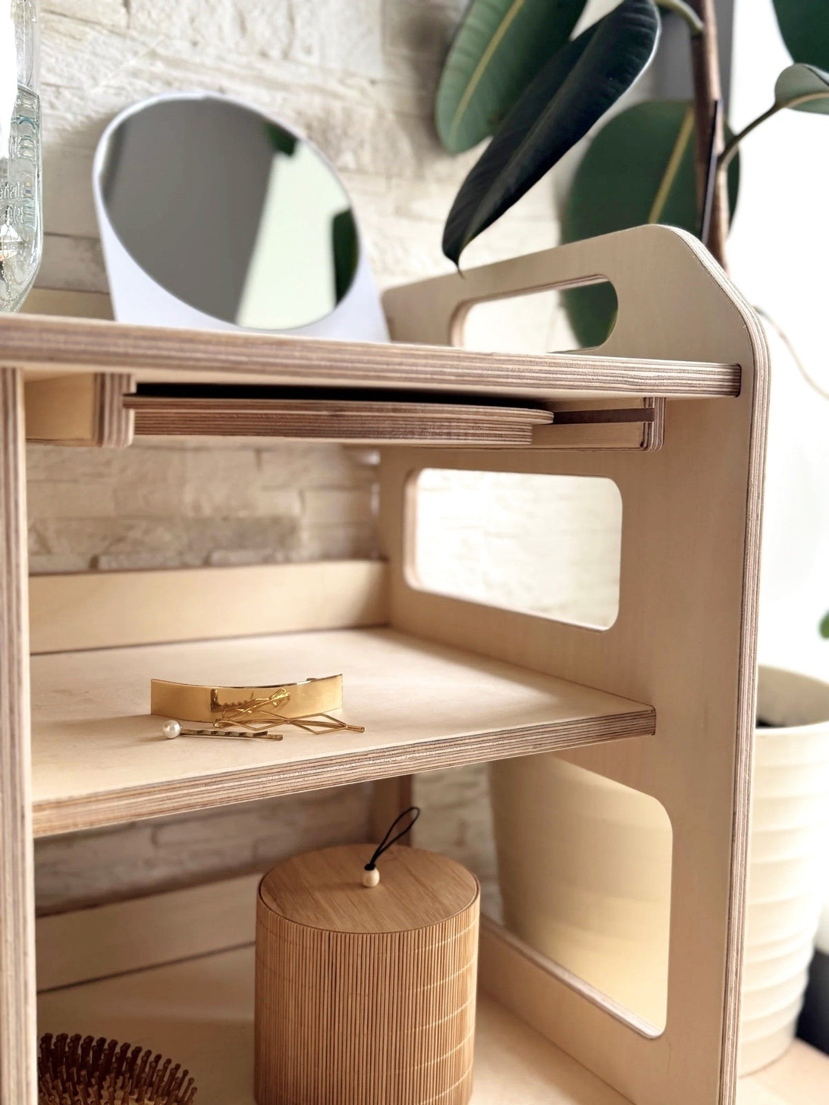 12. Close-up of Montessori washbasin shelves with mirror and wooden accessories