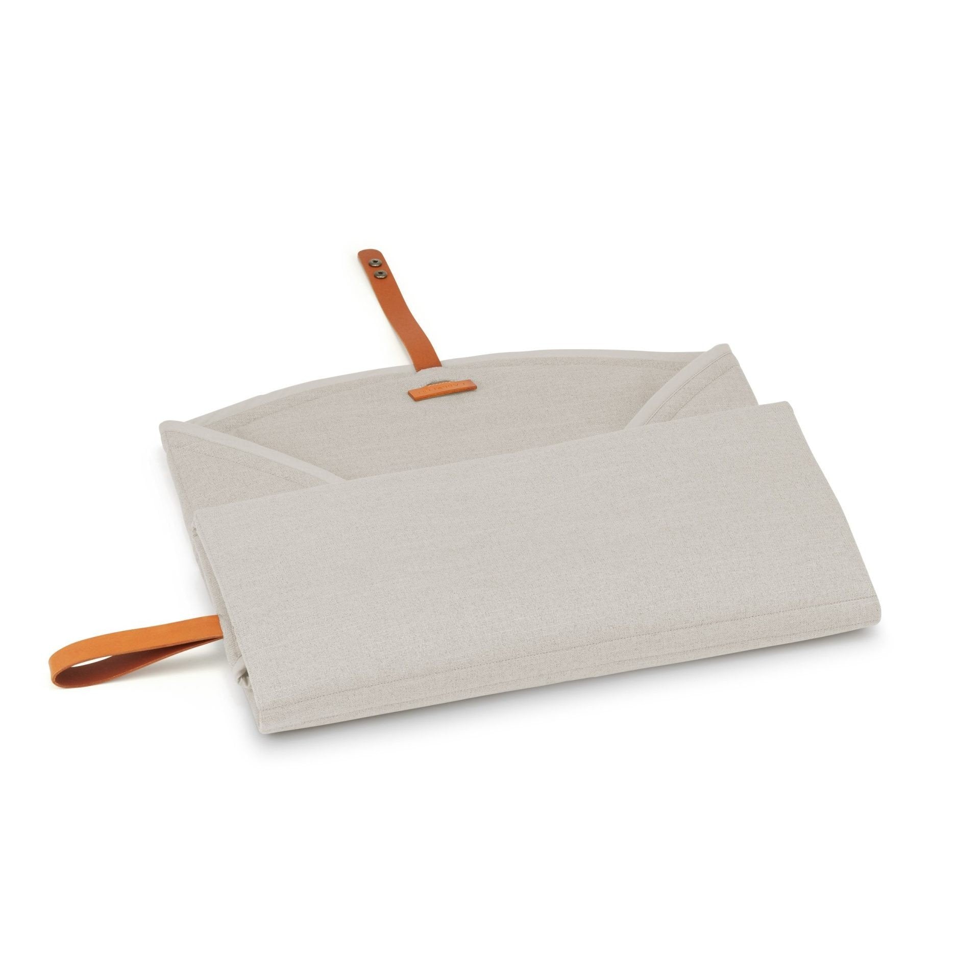 3. Partially unfolded beige Okka travel mat with brown leather strap on white background