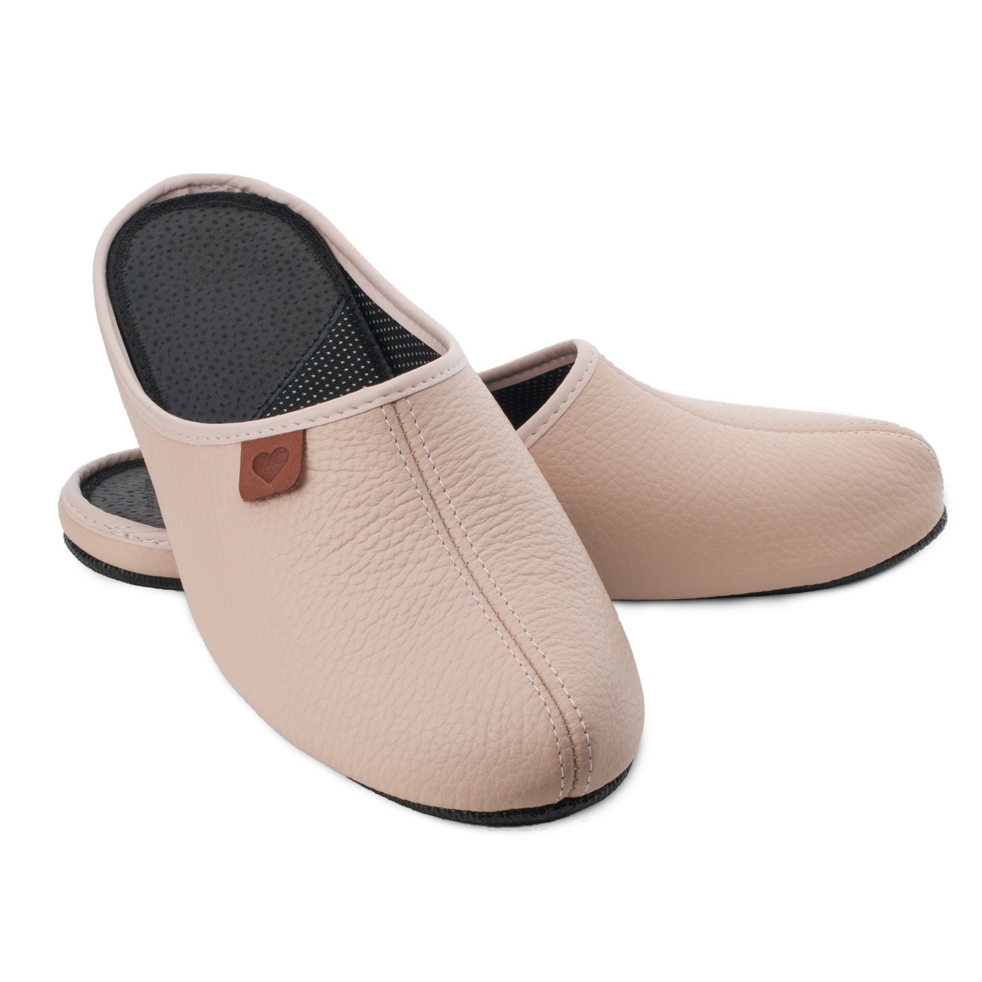 4. Pair of beige leather slippers Sänna by Omaking, displayed in a studio setting
