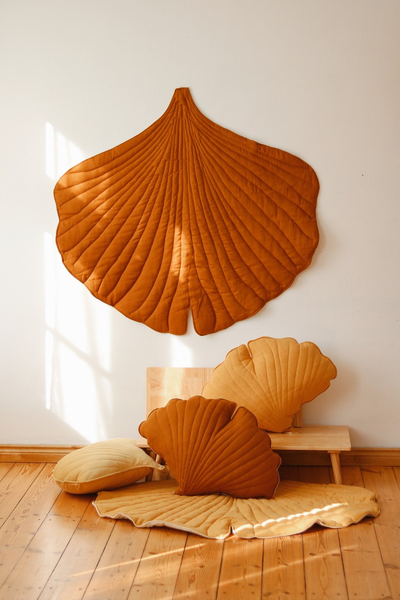 1. Room setting with caramel ginkgo leaf playmat and matching cushions, highlighting decorative and functional use