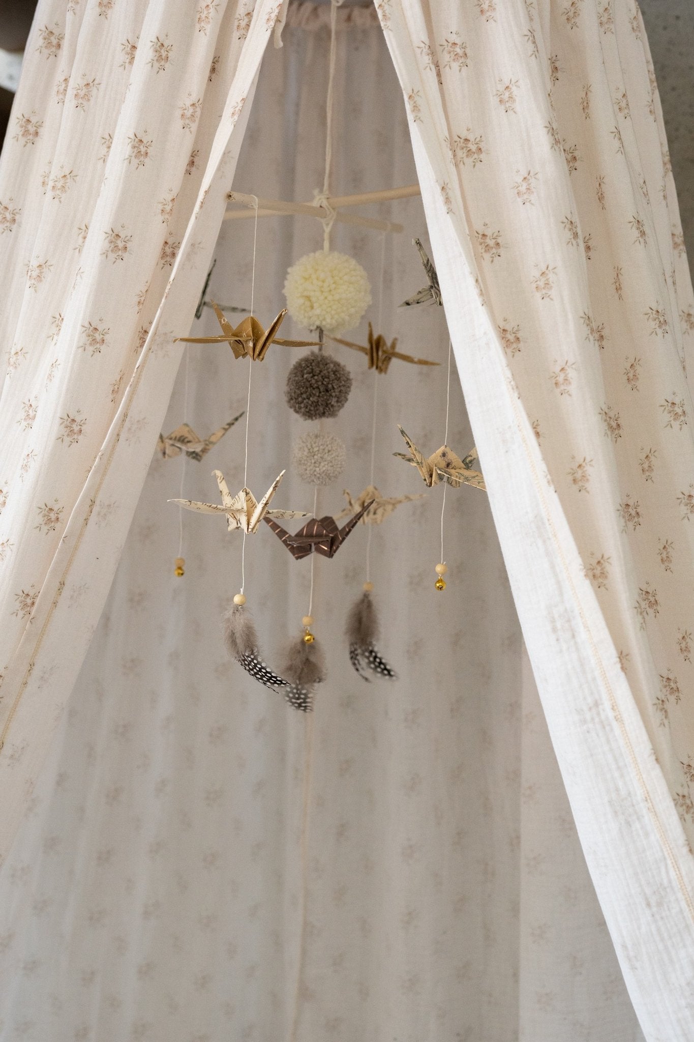 4. Close-up of hanging ornaments inside beige floral canopy, showcasing intricate details