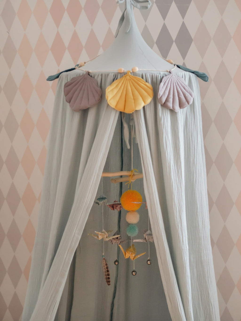 4. Close-up of mint green canopy with hanging ornaments and shell decorations