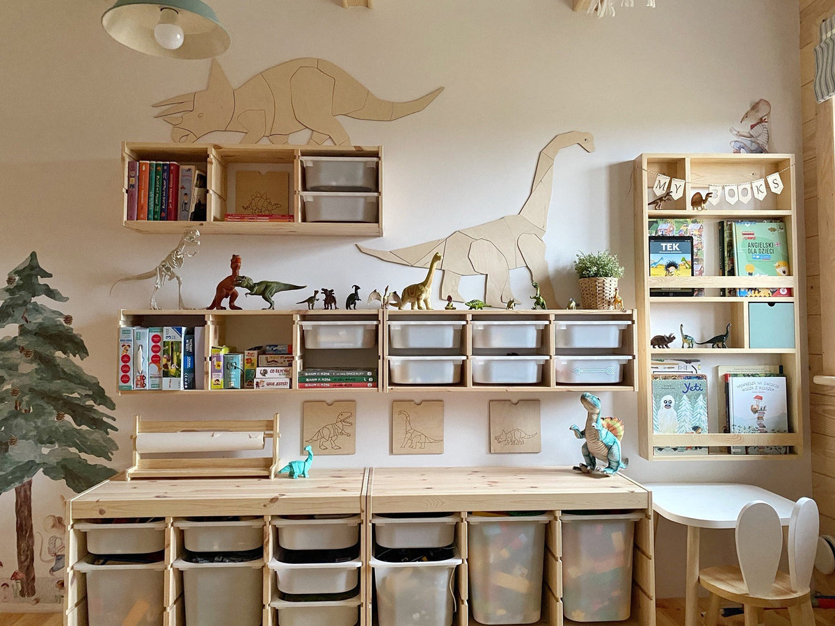 2. Playroom featuring wooden diplodocus wall decoration with shelves filled with books and dinosaur figures