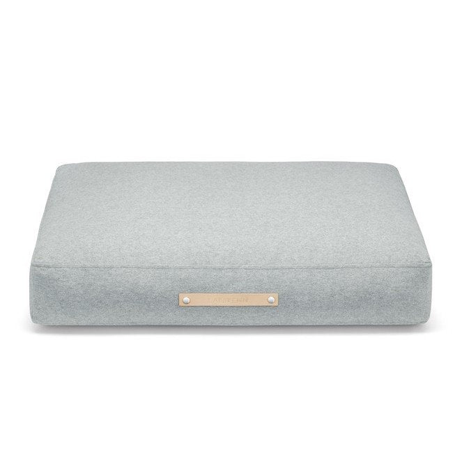 2. Studio shot of Labbvenn Oslo Cushion in light grey with leather label, showcasing minimalist design and premium materials