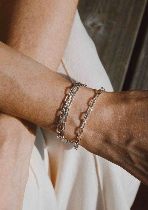 4. Close-up of silver paper clip bracelet on woman's wrist in natural light