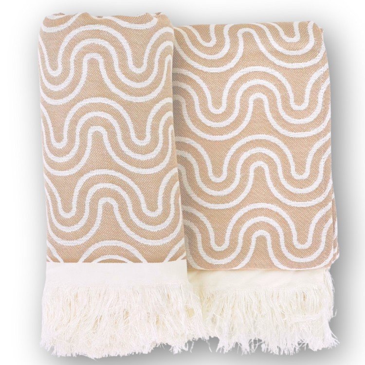1. Beige bamboo towel with white wave pattern and fringed edges, folded on a white background