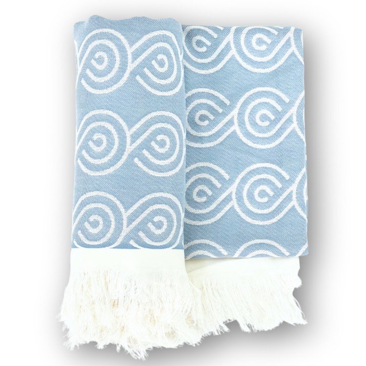 2. Blue bamboo towel with white swirl pattern and fringed edges, folded on a white background