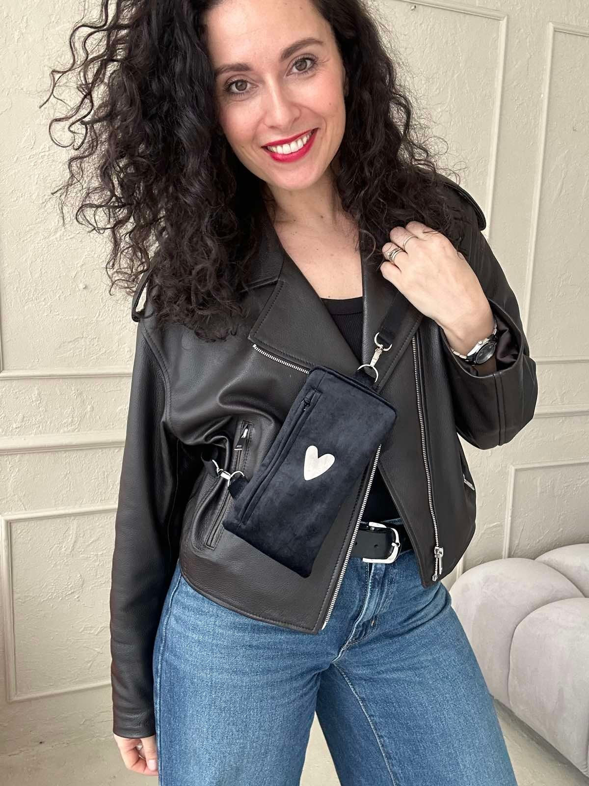 1. Women's black velour phone bag with heart design by Garbanota, worn crossbody with leather jacket and jeans