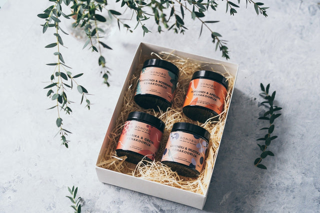 1. BONOBO Piece of Heaven gift box with four body scrubs in a white box on a textured surface with greenery