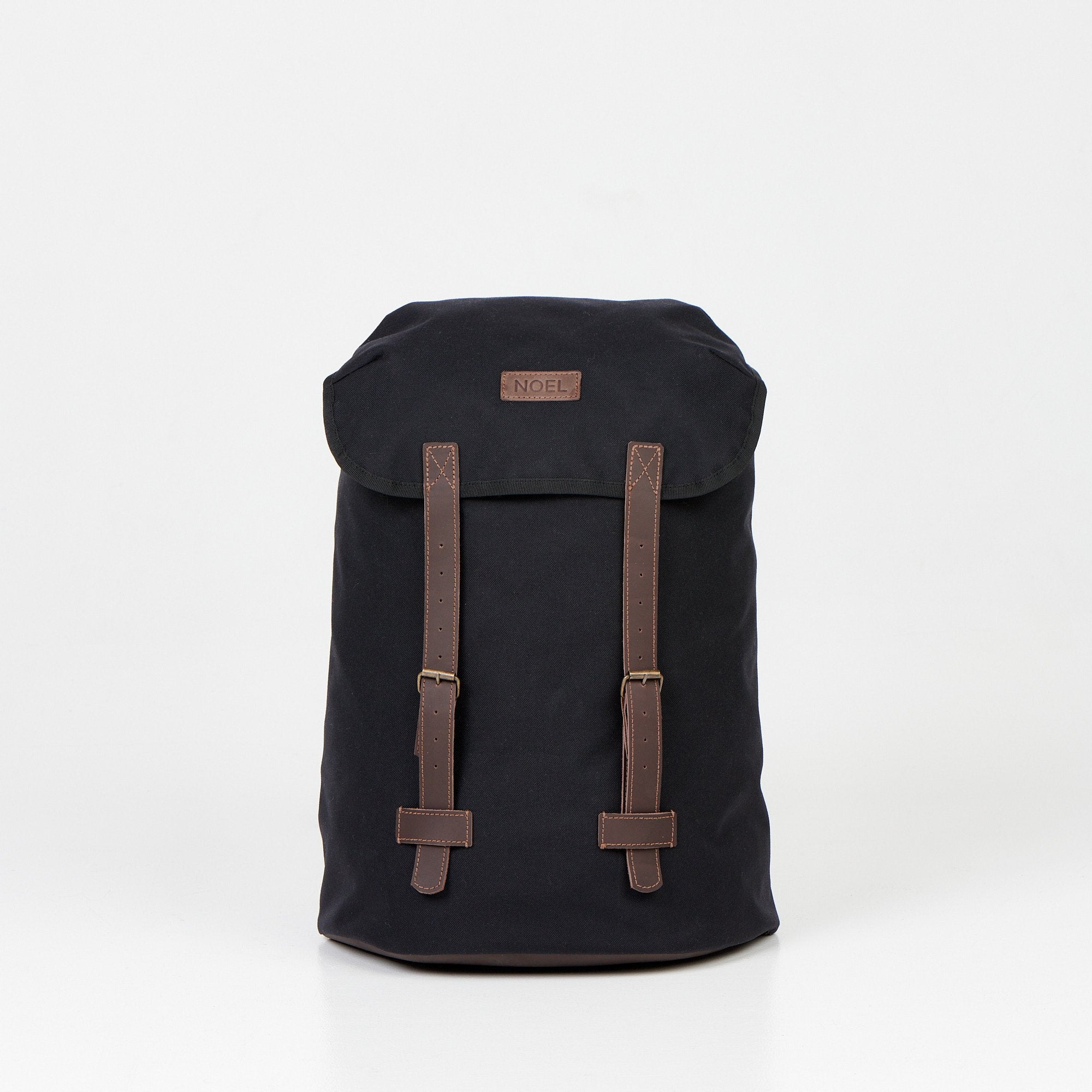 1. Noel Cafe Handmade Backpack in black Cordura, front view with brown straps, studio setting