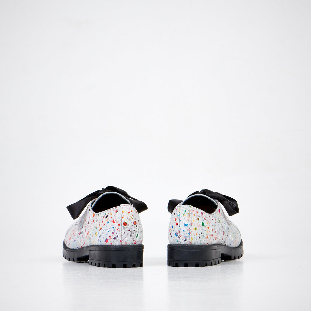4. Unisex Samelin Dotted Widgets sneakers in white with colorful dots and black bow, rear view in studio