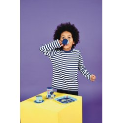 1. Child in striped shirt drinking from blue cup of Floss & Rock construction-themed tea set on yellow table against purple background