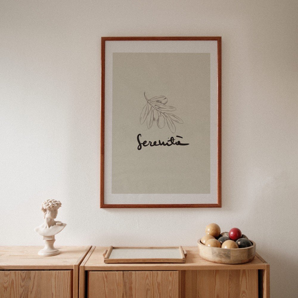 5. Terra Mamma Serenita poster framed and displayed on a wooden cabinet with decorative items