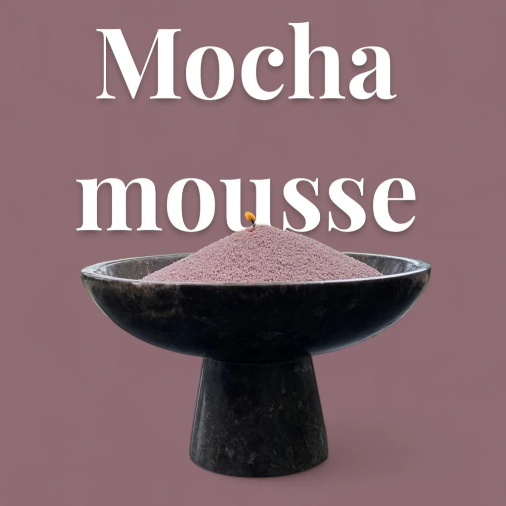4. Mocha mousse colored candle sand in black pedestal bowl with lit wick, large text 'Mocha mousse' on pink background