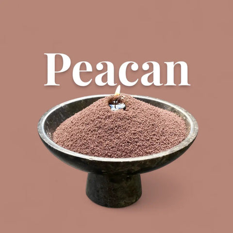 2. Pecan powdered candle in black bowl with lit wick and 'Peacan' text on brown background