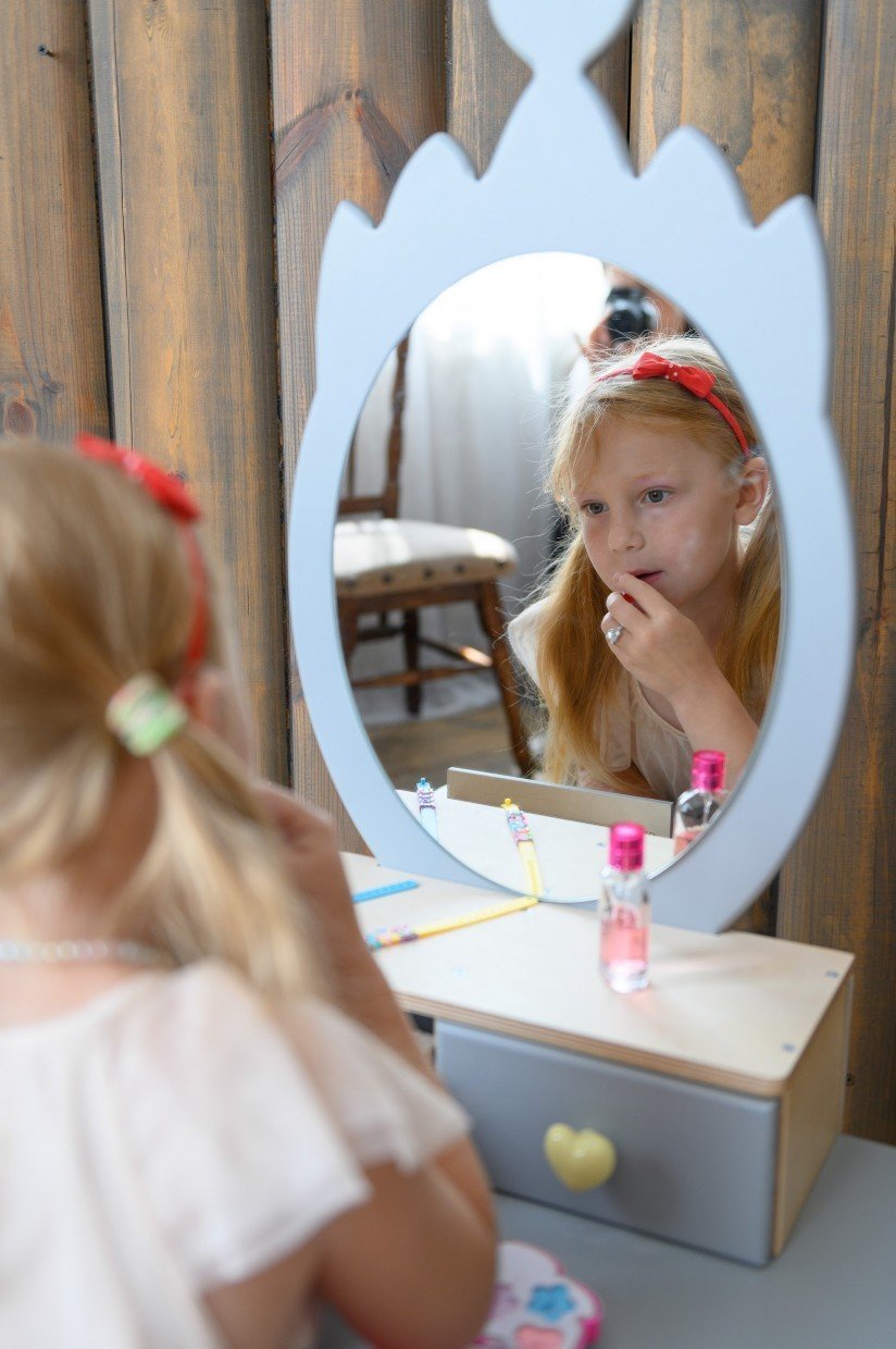 6. Girl applying pretend makeup at grey princess beauty table with heart-shaped mirror