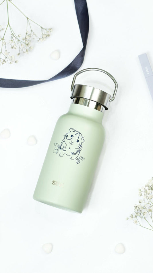 2. SEIK light green thermos with guinea pig illustration, displayed in a studio setting