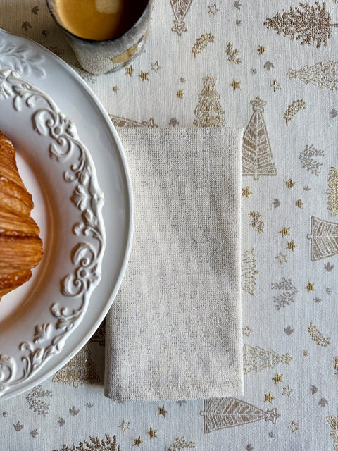 3. Close-up of Hortensias Home Golden Forest tablecloth showing intricate golden fir pattern with folded napkin and croissant