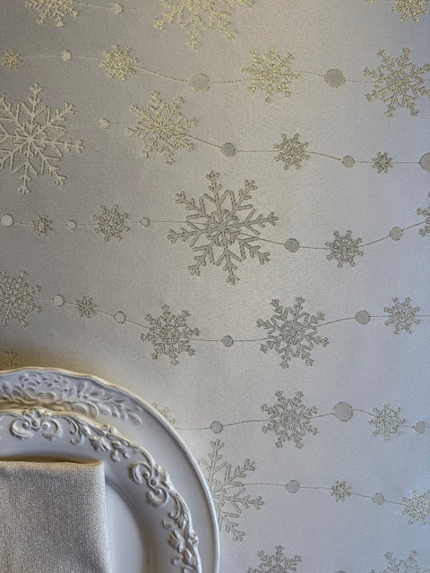 4. Flat lay of tablecloth with golden snowflakes and decorative plate in corner