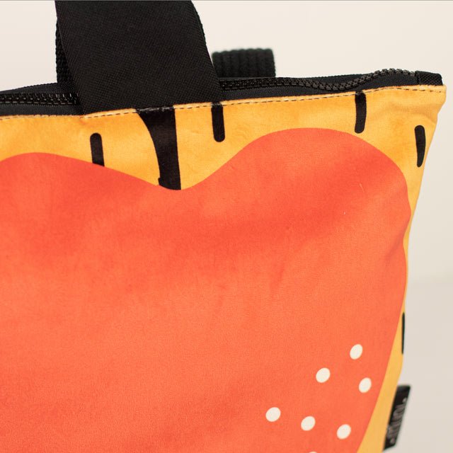 9. Close-up of Muni apple backpack for kids, highlighting vibrant apple motif and quality velvet fabric