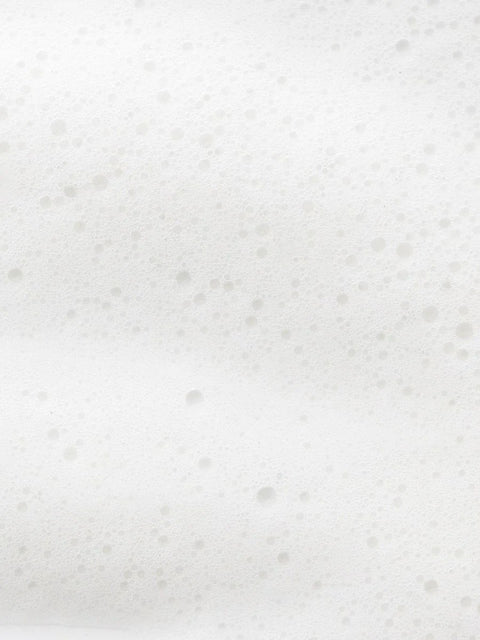 4. Close-up of white foam texture, representing the lather of Magrada rhubarb shampoo