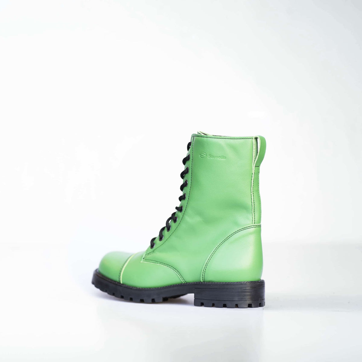 3. Unisex green Samelin 511 Granny Smith boots with zipper, side view showing logo in studio