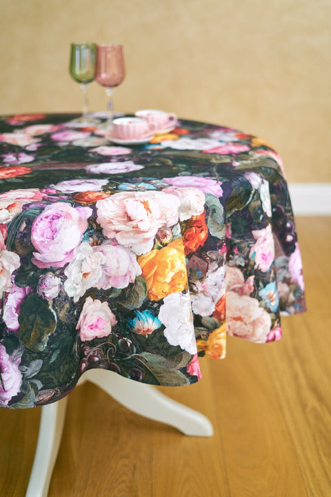 1. Round table with Francine black floral tablecloth, pink and green glasses, and pink teacup in elegant dining room setting
