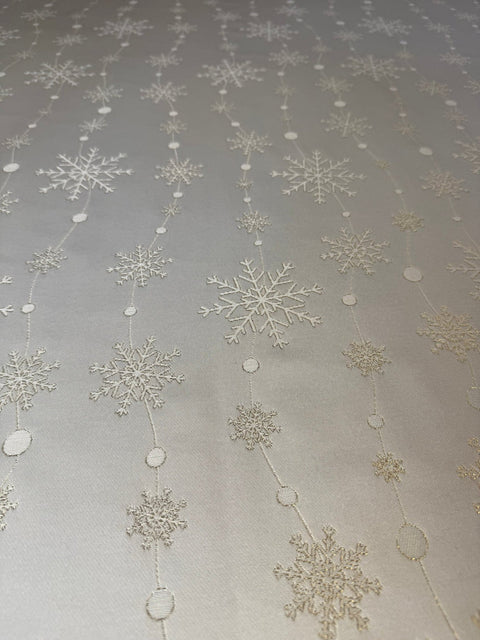3. Close-up of Hortensias Home Golden Snowfall tablecloth showcasing intricate golden snowflake pattern on soft polyester fabric