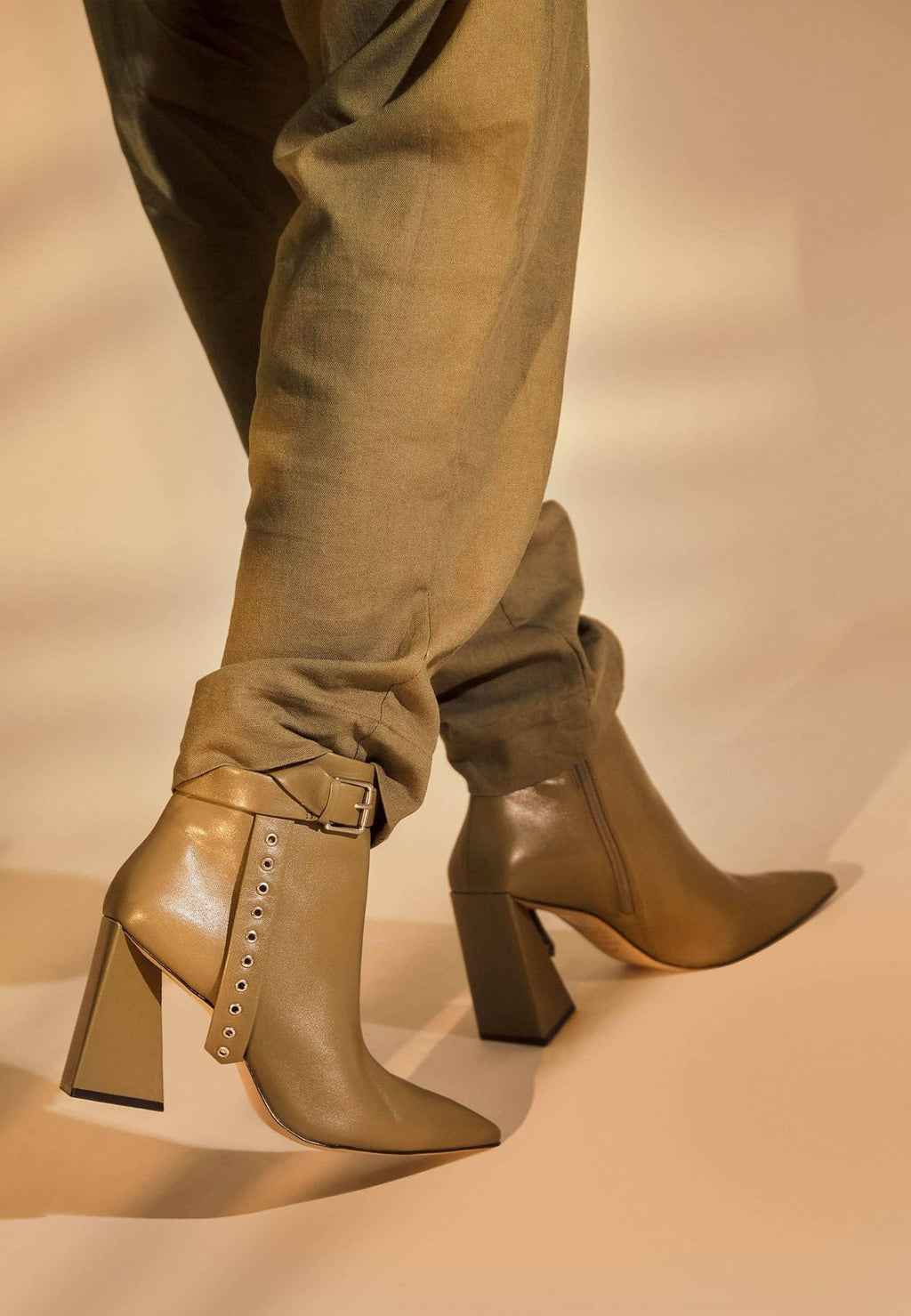 3. Close-up of salvia green leather ankle boots with pointed toe and side buckle detail