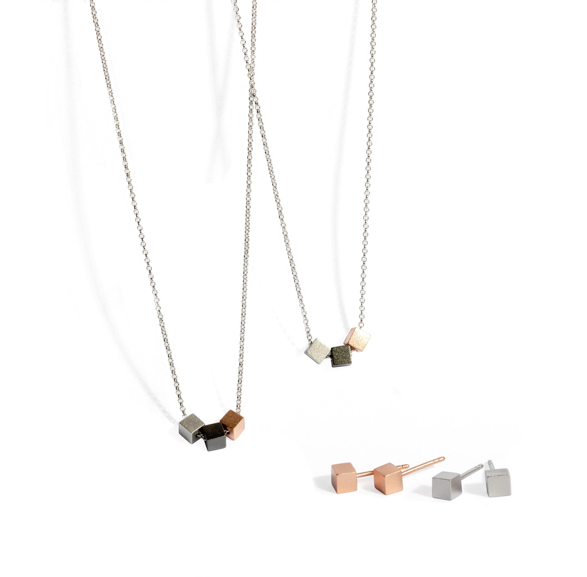 1. MyaMoon Satin Cube Earrings and necklaces in rose gold and silver, showcasing Nordic minimalism and elegance