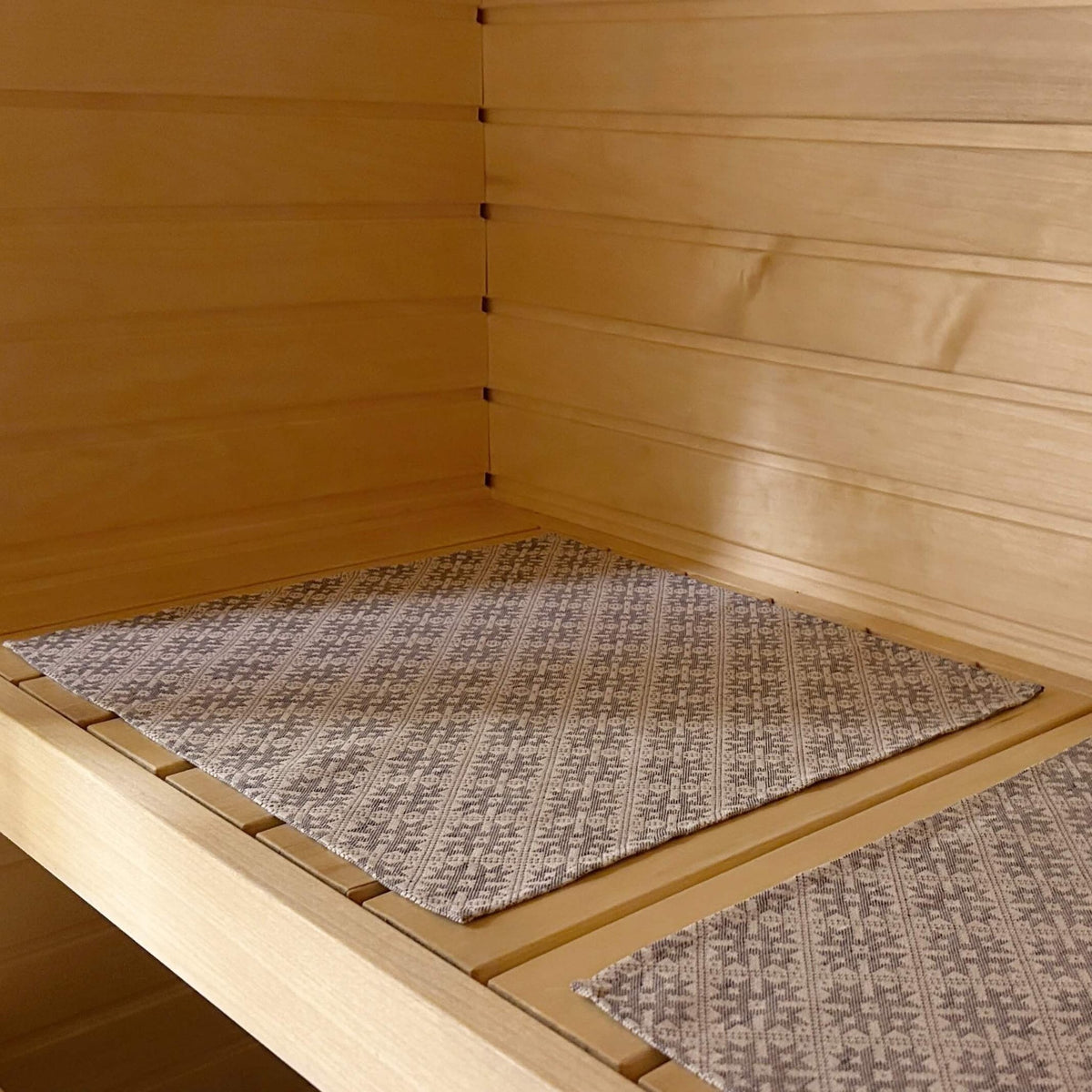 1. Sauna bench with LOKO seating pad featuring traditional Pärnu County mitten pattern in linen and cotton blend
