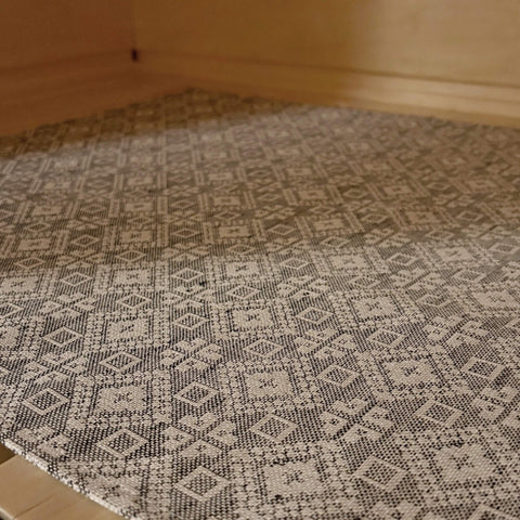 3. Close-up of Tartu County mitten pattern on LOKO sauna seating pad in linen-cotton fabric