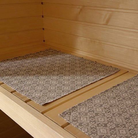 1. Sauna bench with LOKO seating pad featuring Tartu County mitten pattern in linen-cotton blend