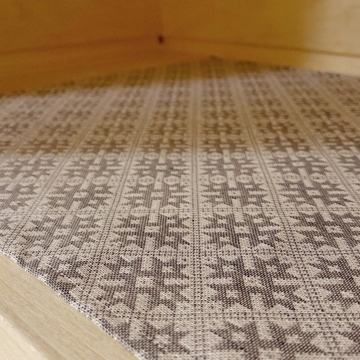 2. Close-up of sauna bench seating pad featuring Pärnu County mitten pattern on linen-cotton blend