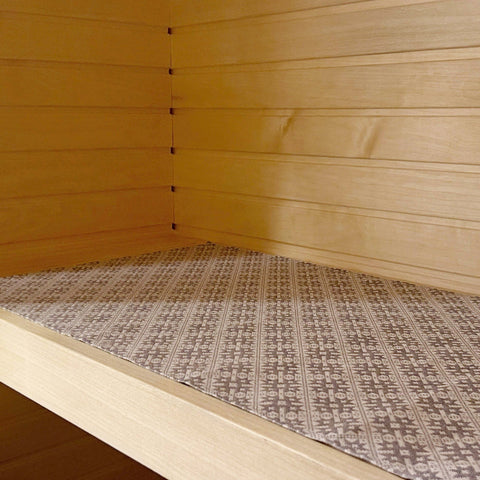 3. Sauna bench seating pad with Pärnu County mitten pattern displayed on wooden bench