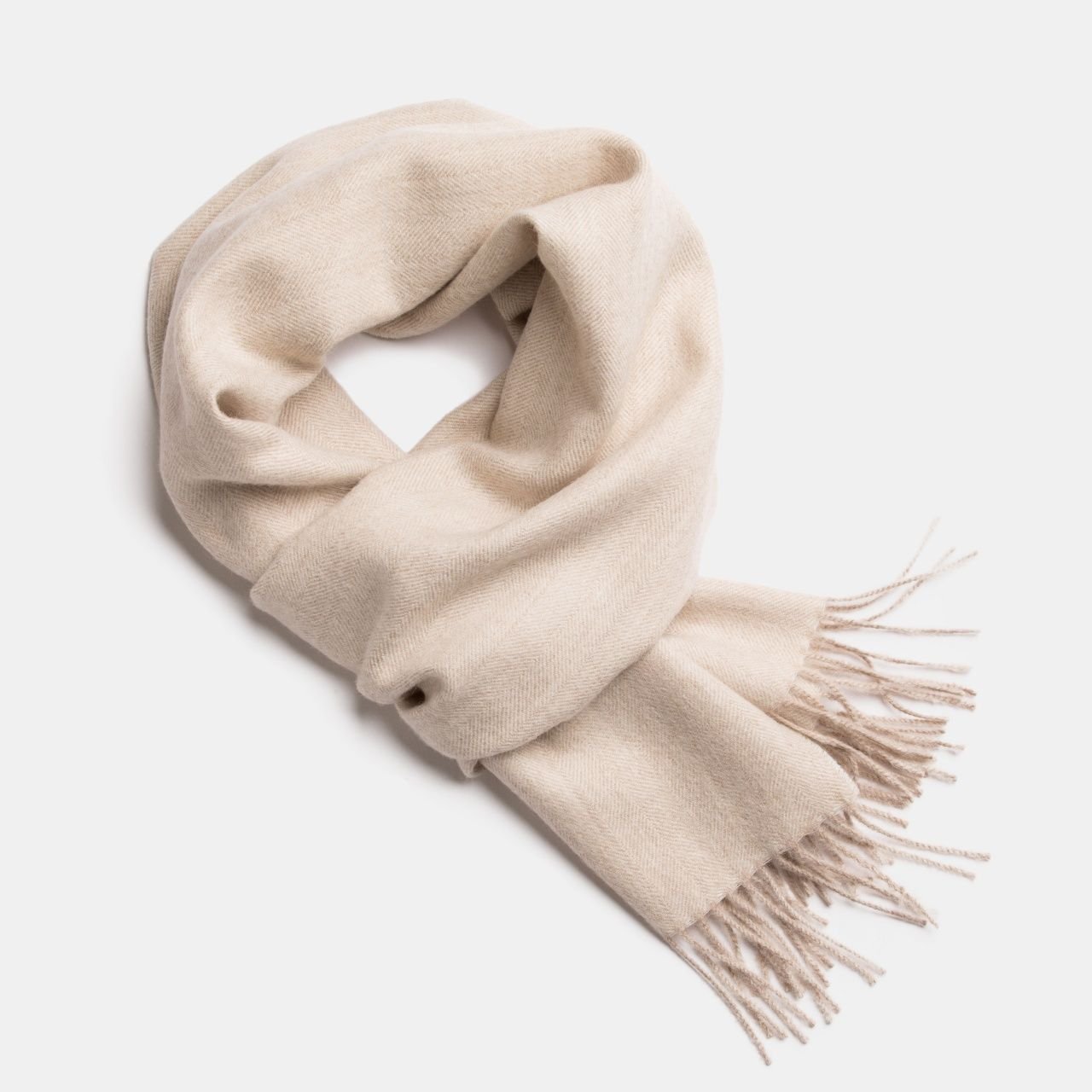 16. Studio image of Alpaka natural baby alpaca wool scarf in cream with fringe detail