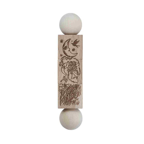 3. Close-up of natural wooden spinning puzzle with engraved illustrations inspired by 'The Secret Garden' and 'Thumbelina'