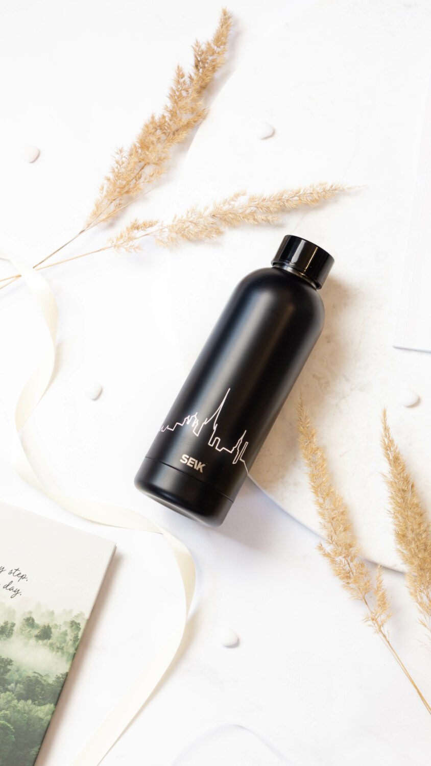 7. SEIK black stainless steel water bottle with Tallinn skyline, on a white background with decorative elements