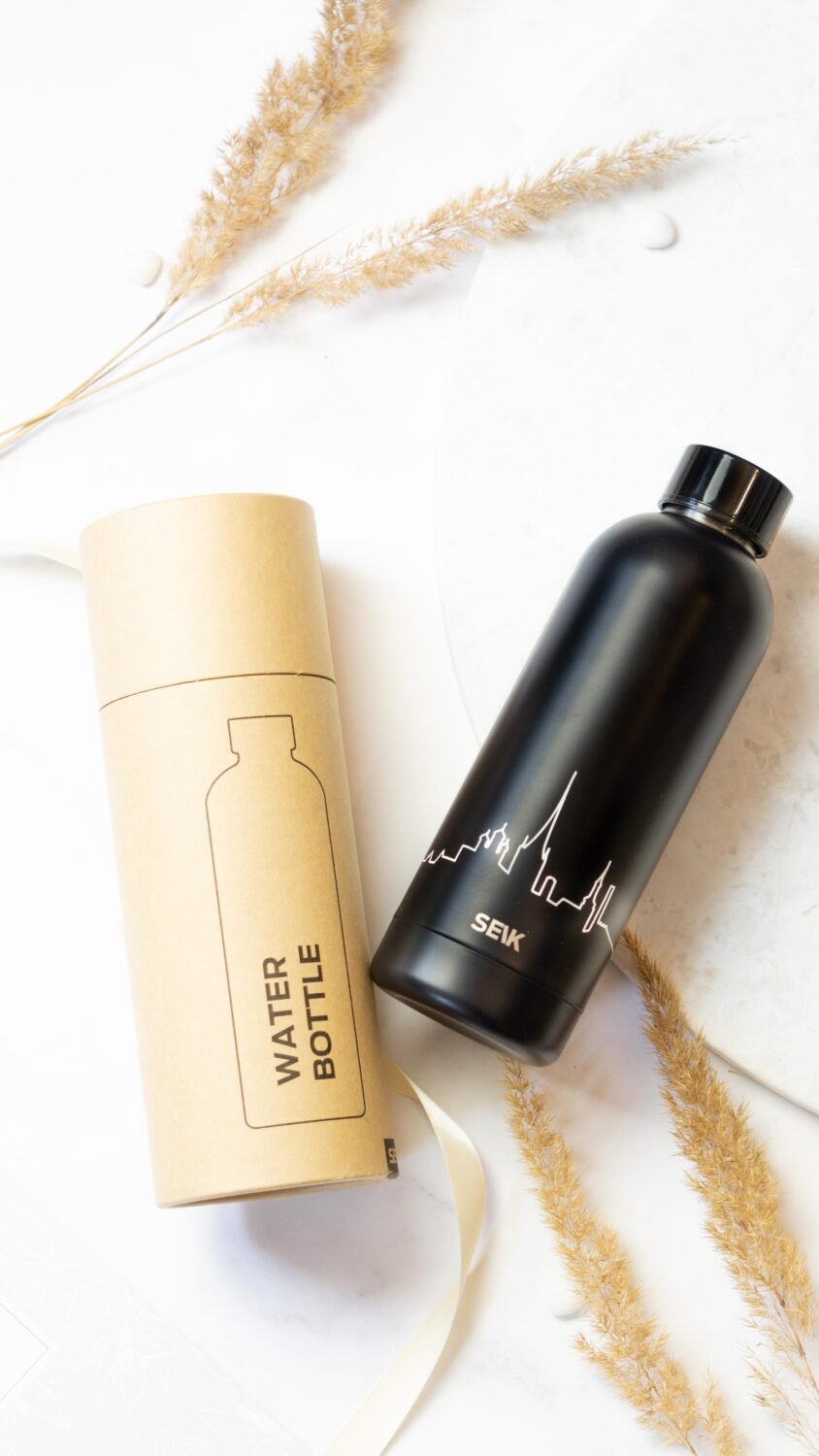 3. SEIK black water bottle with Tallinn skyline, next to its packaging on a white background