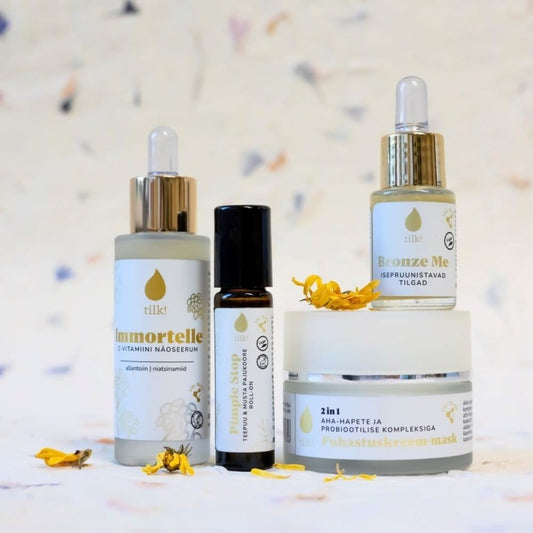2. Collection of Tilk! skincare products including Self-Tanning Drops, Immortelle serum, and 2in1 mask, displayed with floral accents