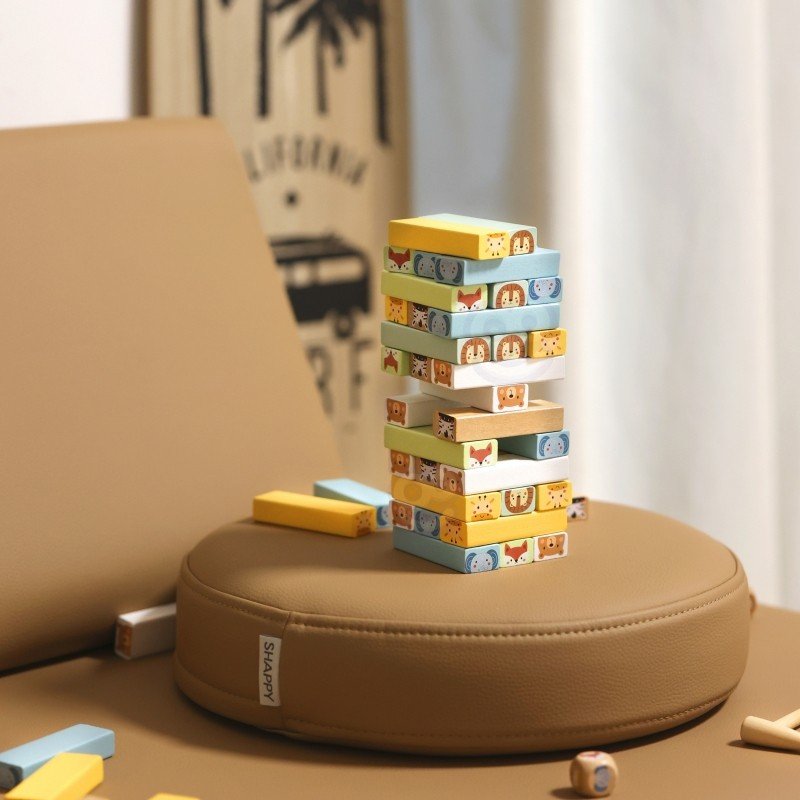 8. Shaky Tower game with colorful animal blocks stacked on a brown cushion