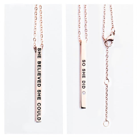 2. Close-up of Olla rose gold necklace with engraved 'She Believed She Could / So She Did' pendant, showing chain and clasp details