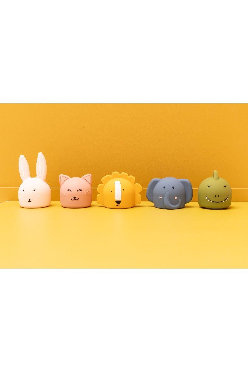 2. Collection of Trixie Baby silicone night lights in animal shapes on yellow background